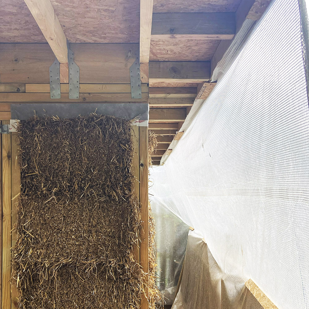 A ceramic studio under construction using straw bales and timber frame