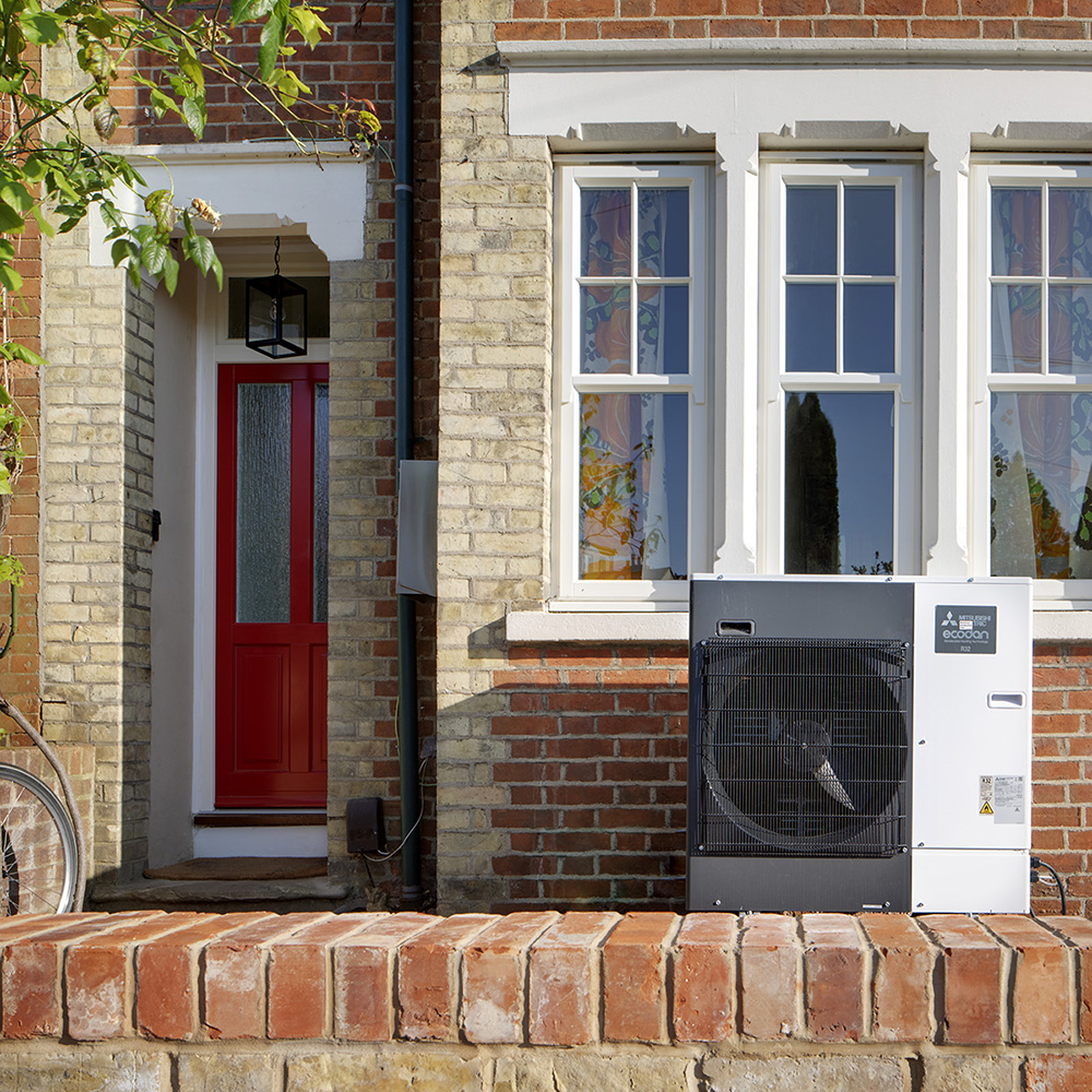 Air source heat pump unit installed in front of a brick Edwardian terraced house